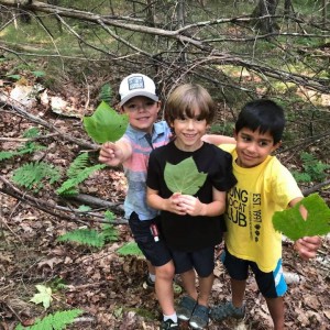 kids holding mnc leaves